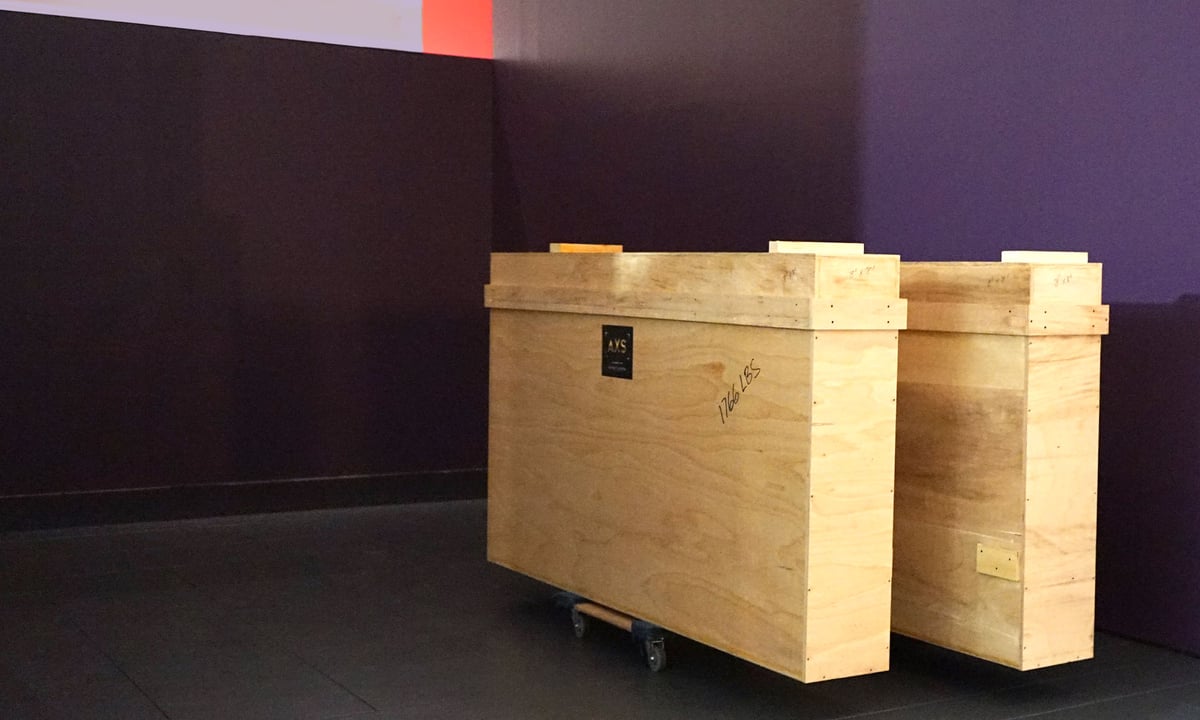 Large rectangular wood crates in front of purple walls