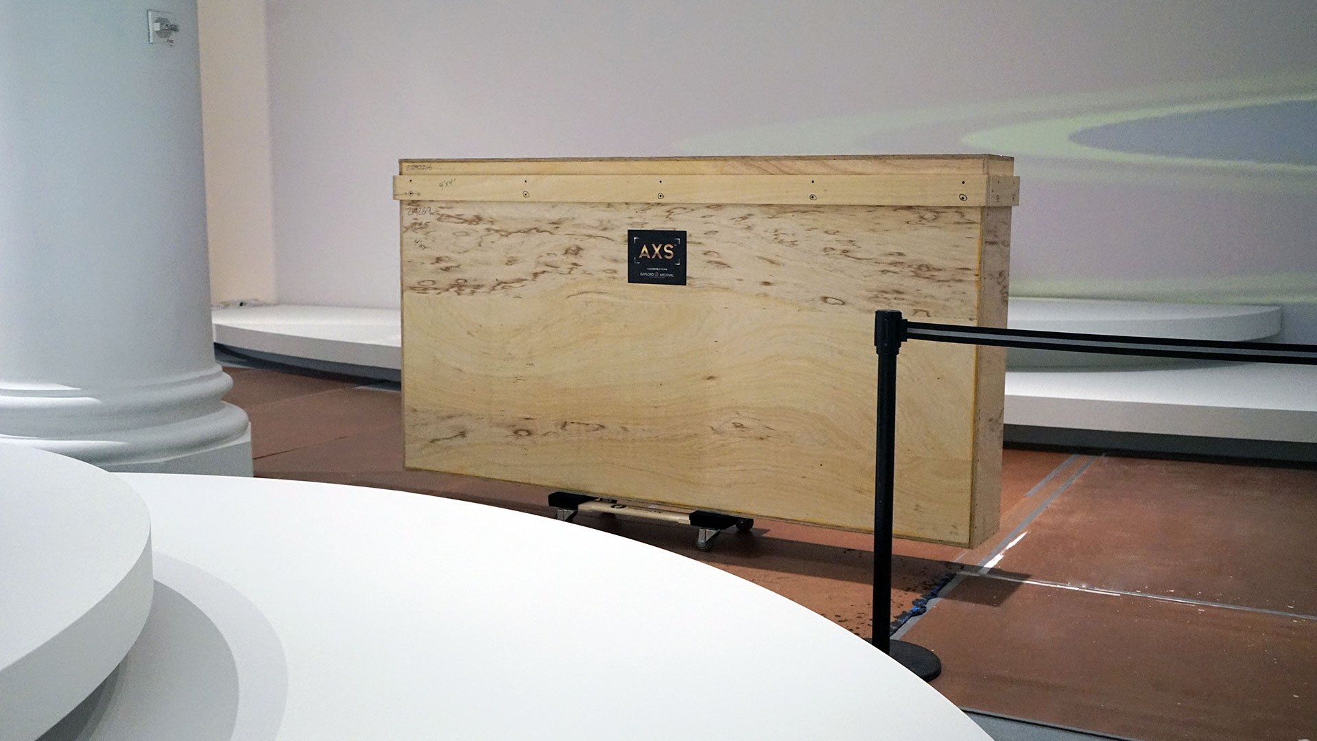 Rectangular wood crate in front of wall with platforms
